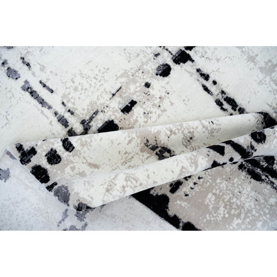 A L V A R luxury handmade rug by Cherom in distressed black and white New Zealand wool.