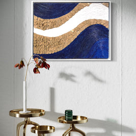 A textured painting of a blue and gold wave, enhancing interior decor with elegance and sophistication for any living space.