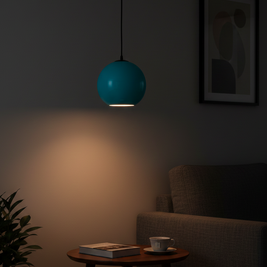Blue pendant light in a dimly lit room with a table and chair.