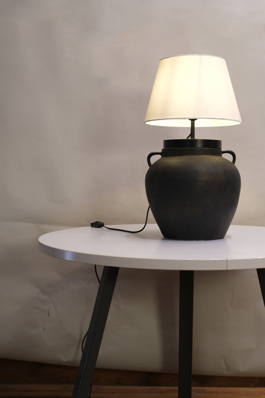 Bohemian table lamp showcasing a unique dune-inspired finish, casting a warm, inviting glow