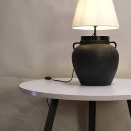Bohemian table lamp showcasing a unique dune-inspired finish, casting a warm, inviting glow