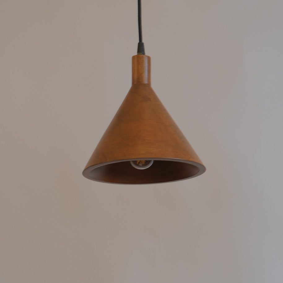 Brown pendant light hanging against a plain wall