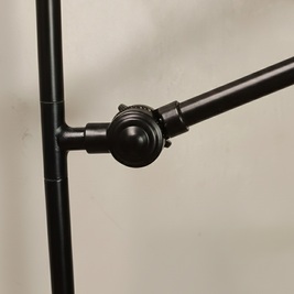 Close-up of a black metal stand on a beige background