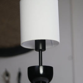 Compact and stylish table lamp showcasing a bold geometric base and clean white lampshade.