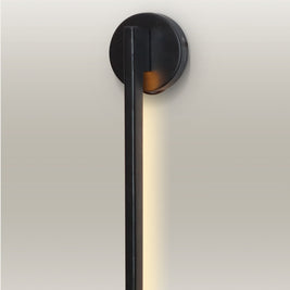 Contemporary LED linear wall lamp, featuring a minimalist black design and warm light for functional and ambient lighting.