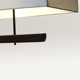 Contemporary dining light with a fabric shade and black rod suspension