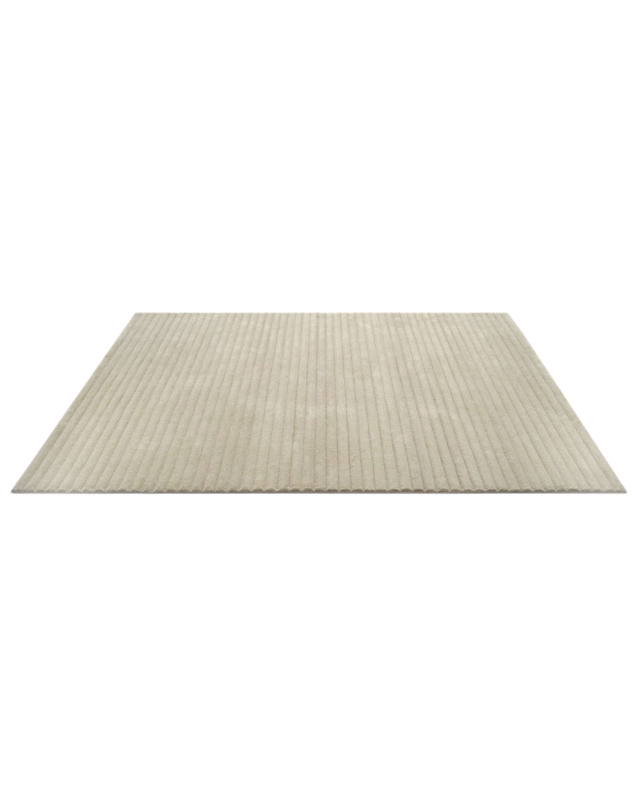 S C U L P T E D - C O R D U O Y luxury handmade rug by Cherom, made of New Zealand wool in light beige tones.