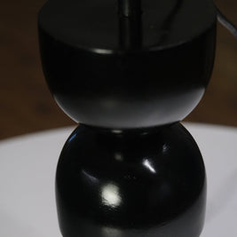Designer table lamp with a unique stacked black base and contrasting white shade, perfect for interiors.