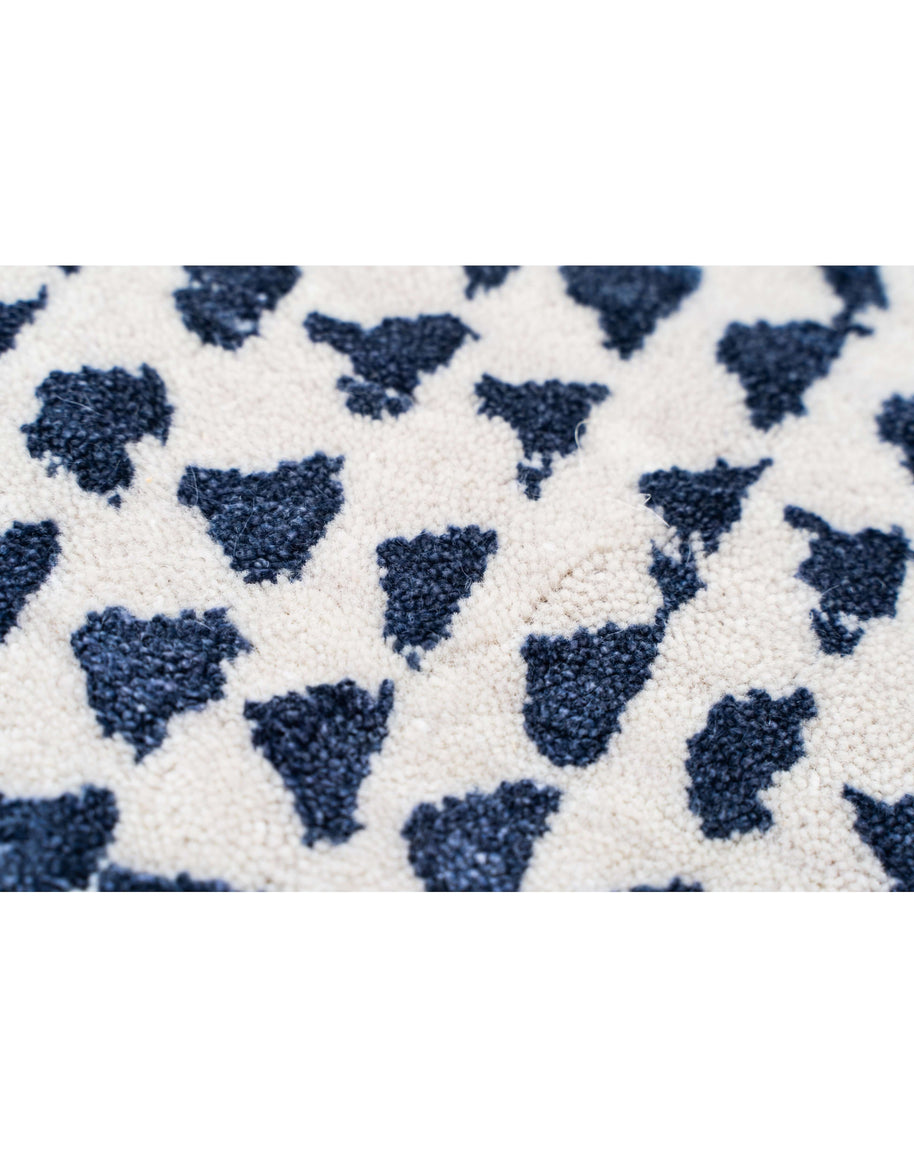 O D M É luxury handmade rug by Cherom in navy and cream wool.
