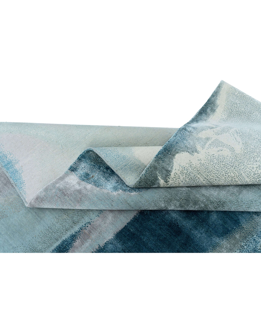 B A X T E R luxury handmade rug by Cherom, modern design, New Zealand wool, blue tones, fine craftsmanship.