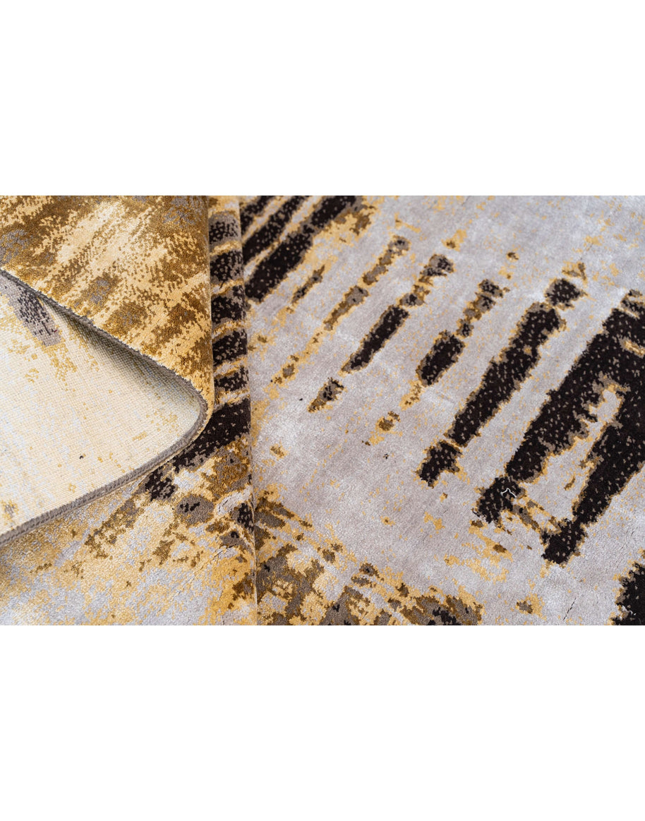 L Y M A N luxury handmade rug by Cherom in wool and viscose, modern design with gold, gray, and black pattern.