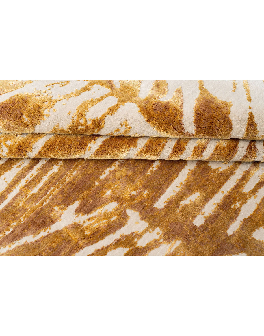 A X E L luxury handmade rug by Cherom in rich gold tones, made from New Zealand wool, with a modern contemporary design.