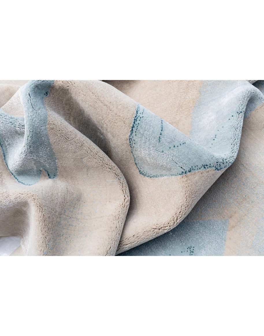 M O D E N A luxury handmade rug by Cherom, made from New Zealand wool with a modern design in soft beige and blue.