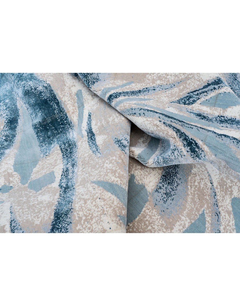 L O R E T O luxury handmade rug by Cherom in soft blue and beige hues.