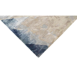 E V O K E luxury handmade rug by Cherom in soft grey, muted blue, and warm beige tones, made of New Zealand wool.