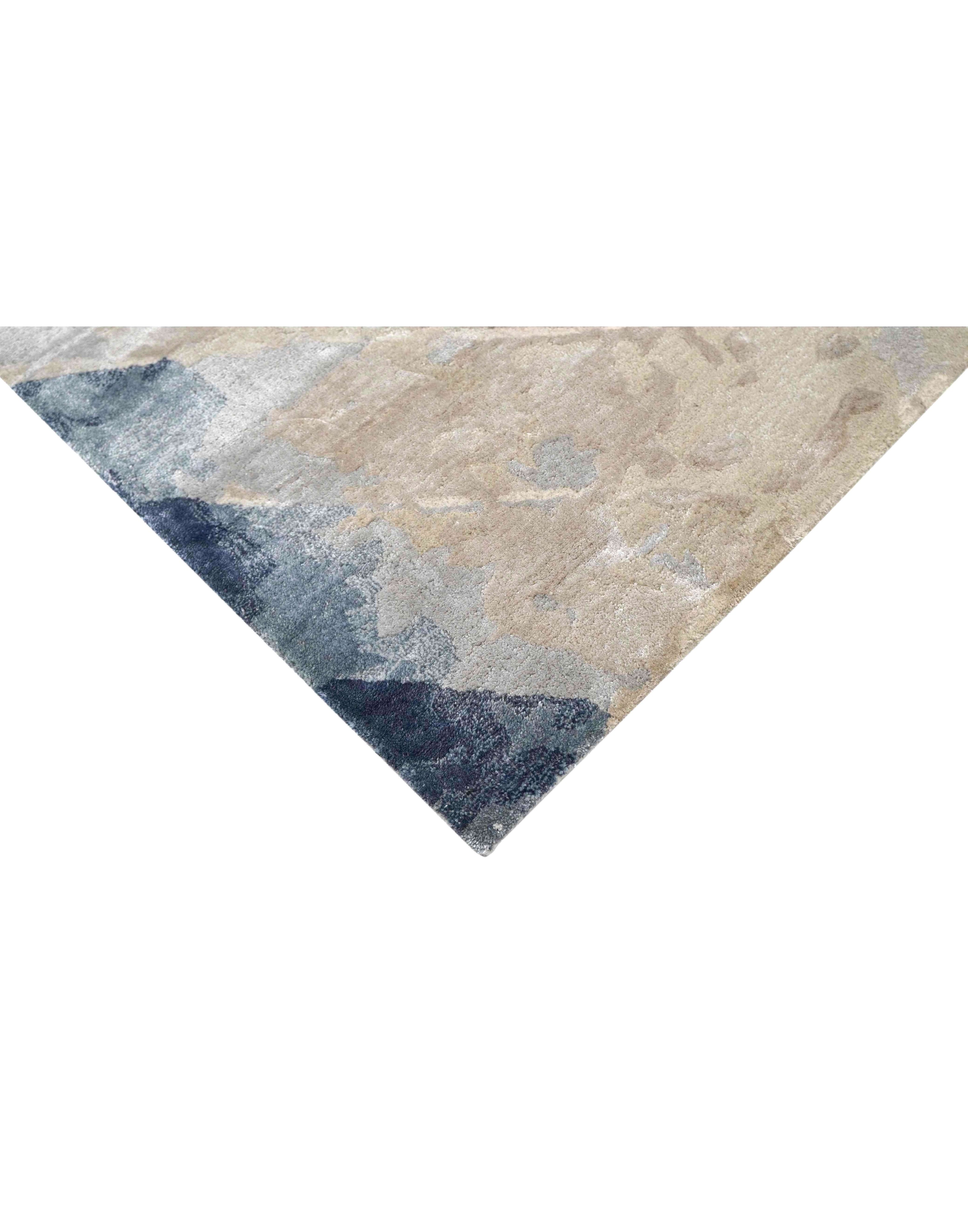 E V O K E luxury handmade rug by Cherom in soft grey, muted blue, and warm beige tones, made of New Zealand wool.