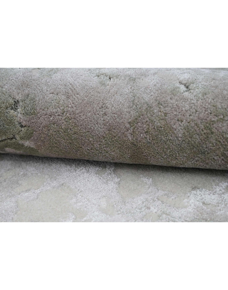 M O S S luxury handmade rug by Cherom, made from New Zealand wool, featuring earthy green and stone grey hues.
