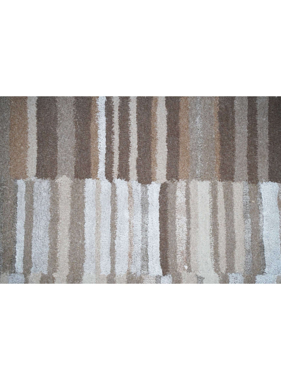 B A S K luxury handmade rug by Cherom in rich browns and pale beiges, crafted from New Zealand wool.