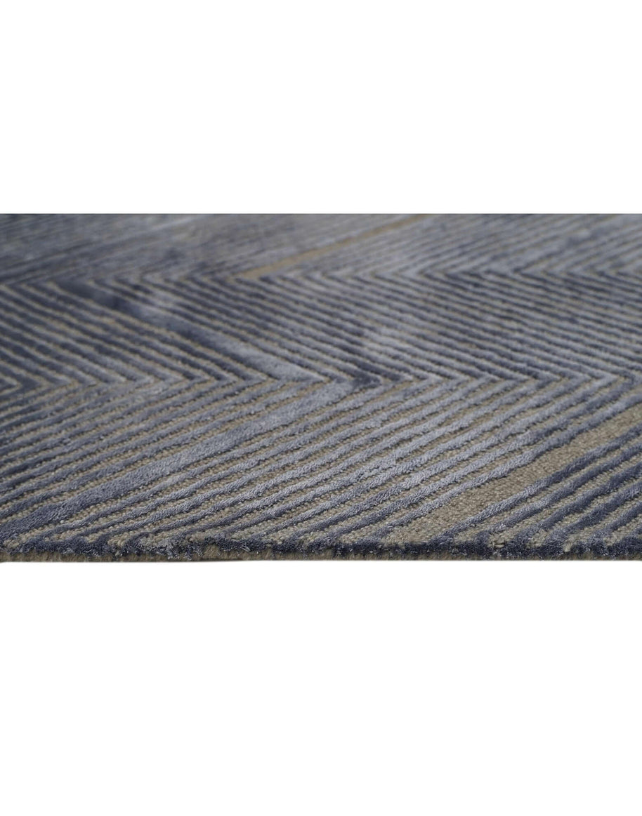 C O N T O U R - A E R O luxury handmade rug by Cherom in grey-blue New Zealand wool with a chevron pattern.