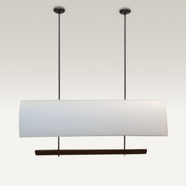 Edgy black rods suspend the luxe pendant dining light over a modern dining table.