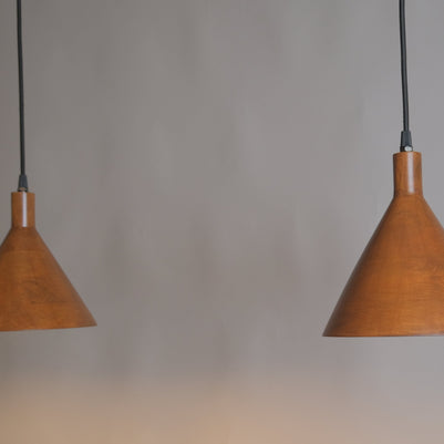 Two brown pendant lights hanging against a gray background
