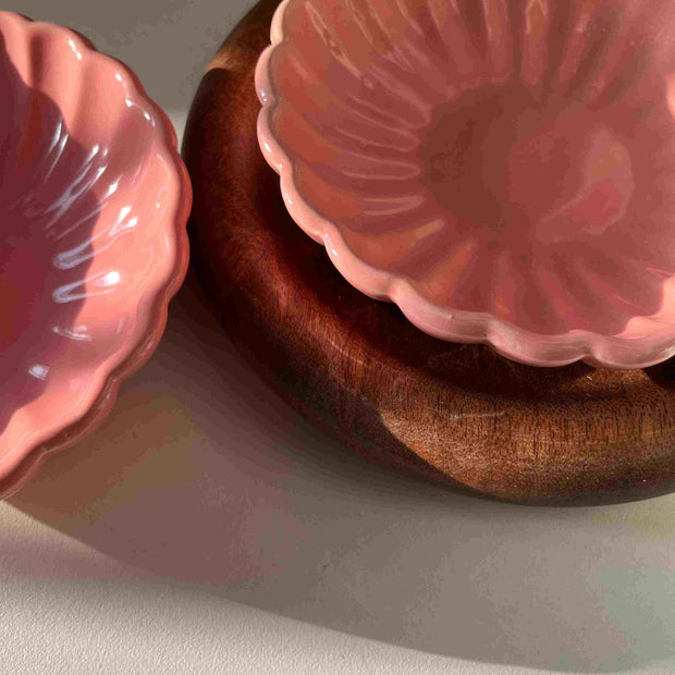 Pink flower-like dessert bowl in a wooden tray on a light gray background