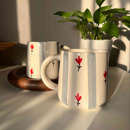Grey striped ceramic mug with cream/white base, pretty red floral motif