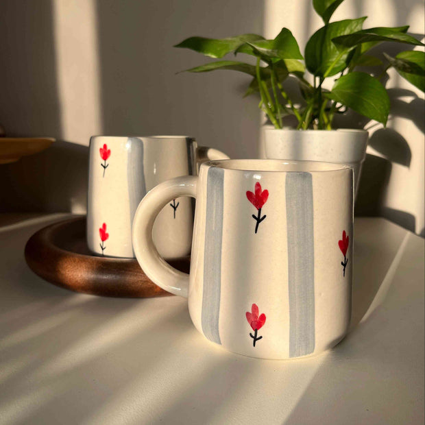 Grey striped ceramic mug with cream/white base, pretty red floral motif