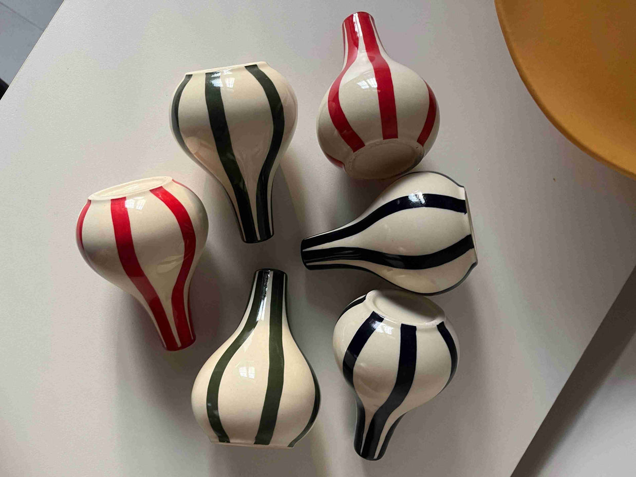 Set of five decorative vases with Blue, green and red stripes on a light gray background