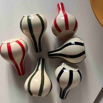 Set of five decorative vases with Blue, green and red stripes on a light gray background