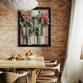 Nature-inspired wall art featuring upcycled books and faux florals in a rustic wooden frame
