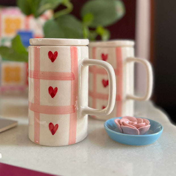 Pink checks with red heart ad a lid. Tall mug and slim. 