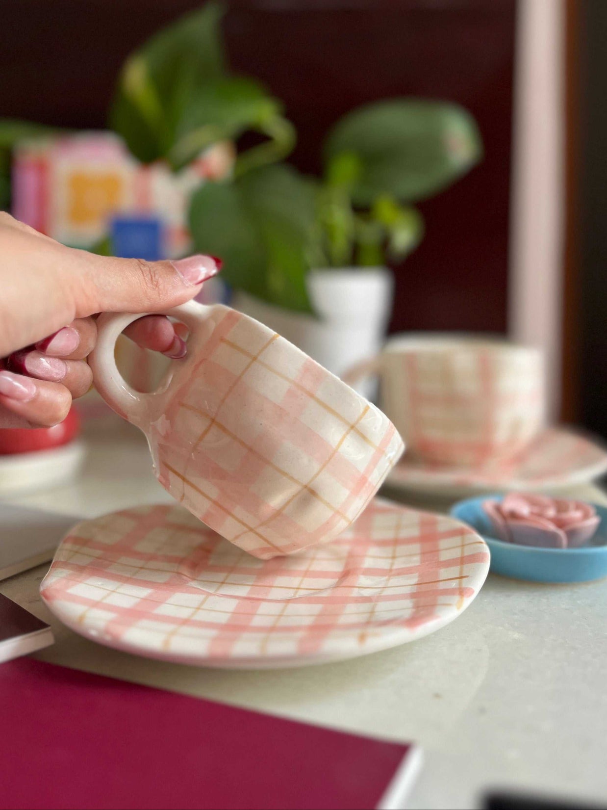 pink and white cup and saucer with a very interesting shape of cup, has checks.