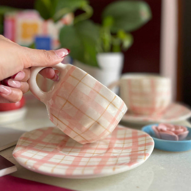 pink and white cup and saucer with a very interesting shape of cup, has checks.