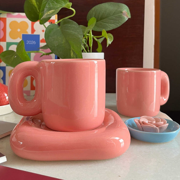 Glossy solid pink coffee mug with saucer