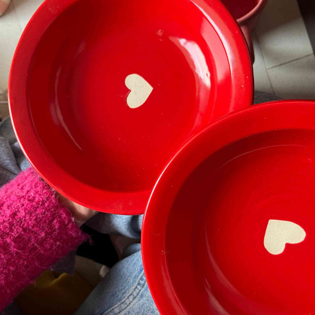 Red pasta fruit plate with white matte heart in the center. 