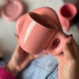 Solid pink ceramic mug with a square saucer