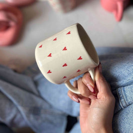 Ceramic mug with small red hearts, coffee, tea, drinking