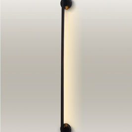 Minimalist LED linear wall lamp with a slender design and warm glow, enhancing a modern room's ambiance