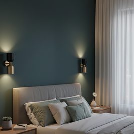 Modern bedroom with a dark green wall, gray bed, and decorative elements.
