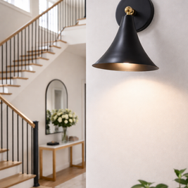 Modern black wall sconce in a home interior setting with staircase and decor.