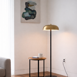 Modern living room with a gold floor lamp, side table, and abstract painting.