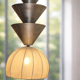 Modern pendant light with tiered design in a room with large windows.