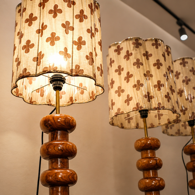 Set of lamps with wooden bases and patterned lampshades on a neutral background