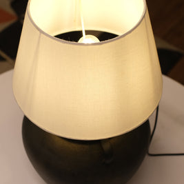 Stylish lamp with a minimalist design, textured sand base, and soft, ambient lighting for versatile use