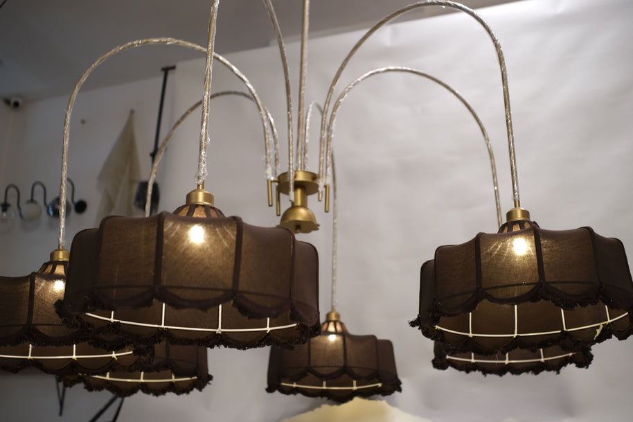 Towering chandelier featuring a minimalist design with sleek metallic branches and warm LED lights