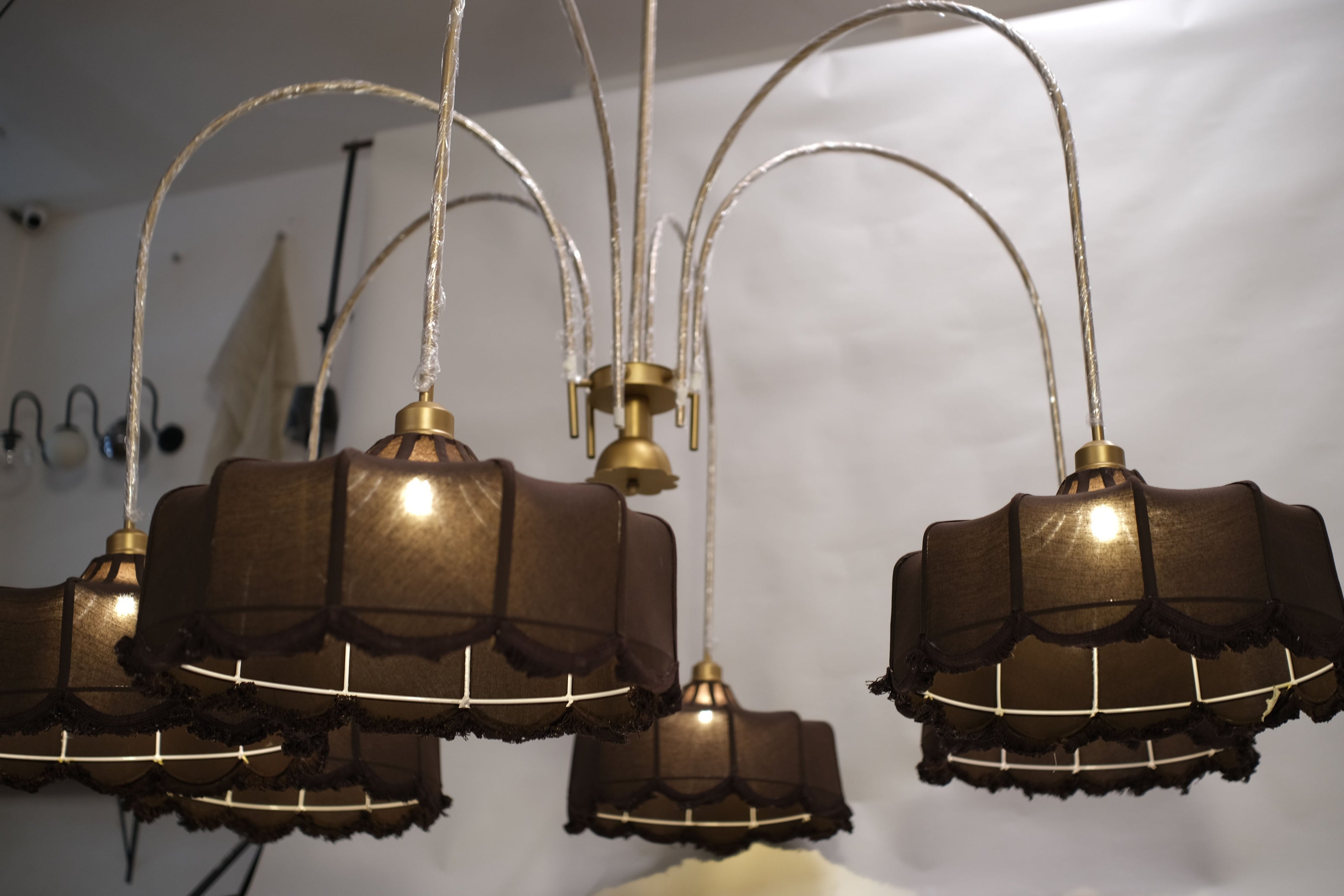 Towering chandelier featuring a minimalist design with sleek metallic branches and warm LED lights