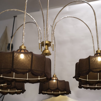 Towering chandelier featuring a minimalist design with sleek metallic branches and warm LED lights