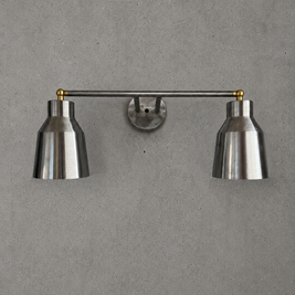 Wall-mounted lamp with two metallic shades on a gray wall