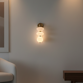 Wall-mounted light fixture in a modern room with a sofa and side table.